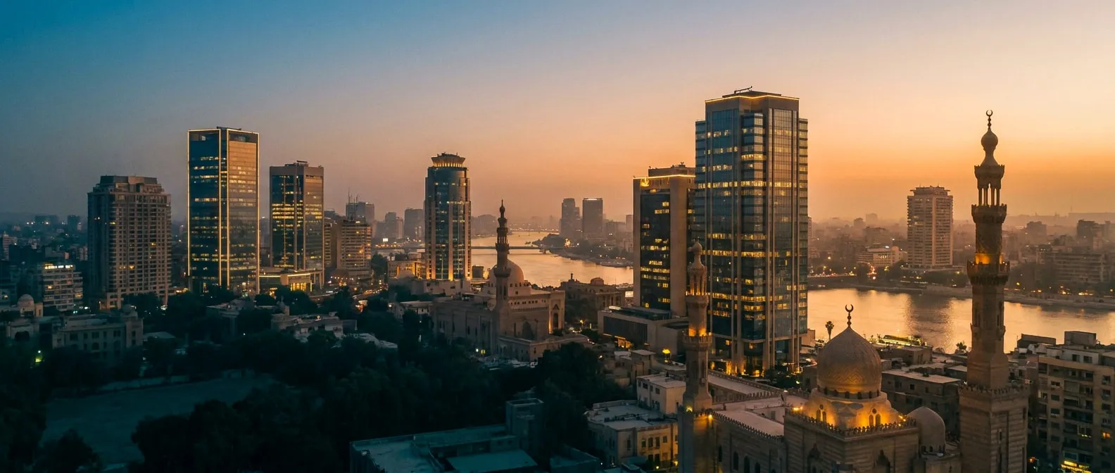 Downtown Cairo business-district skyline at dusk — modern office towers and minarets along the Nile